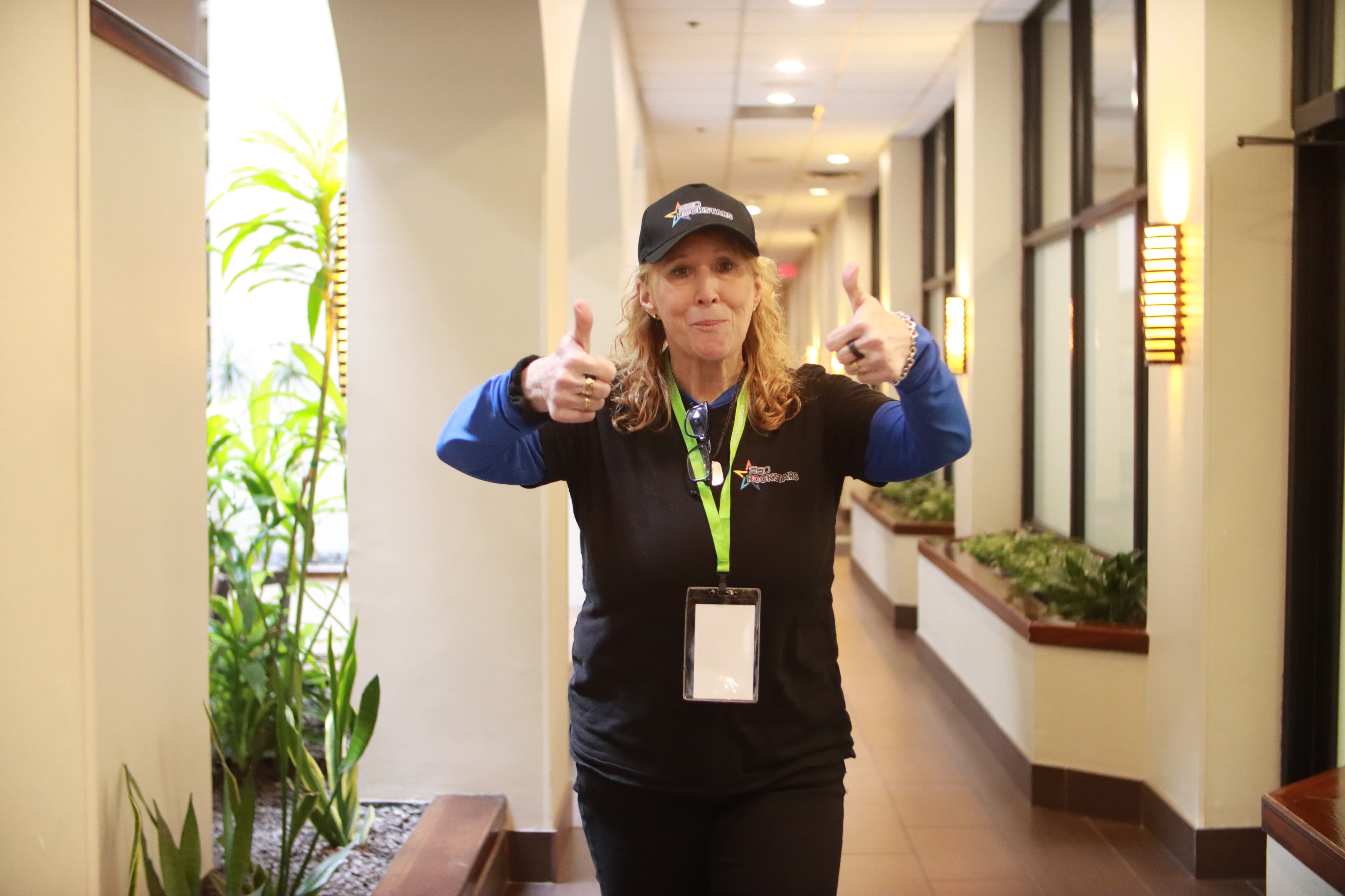 Enthusiastic attendee giving double thumbs up